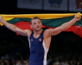 Denmark's Mark Overgaard Madsen, red, competes against Lithuania's Aleksandr Kazakevic during a 74-kg Greco-Roman wrestling bronze medal match at the 2012 Summer Olympics, Sunday, Aug. 5, 2012, in London. (AP Photo/Paul Sancya)